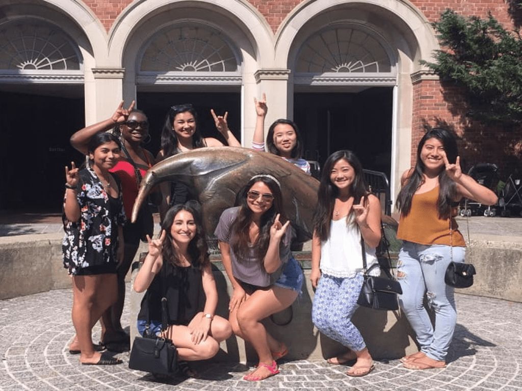 UCI students posing near an anteater statue