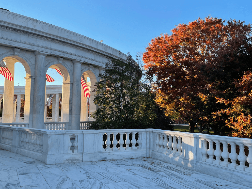 Outdoor view of marble arches with American flags